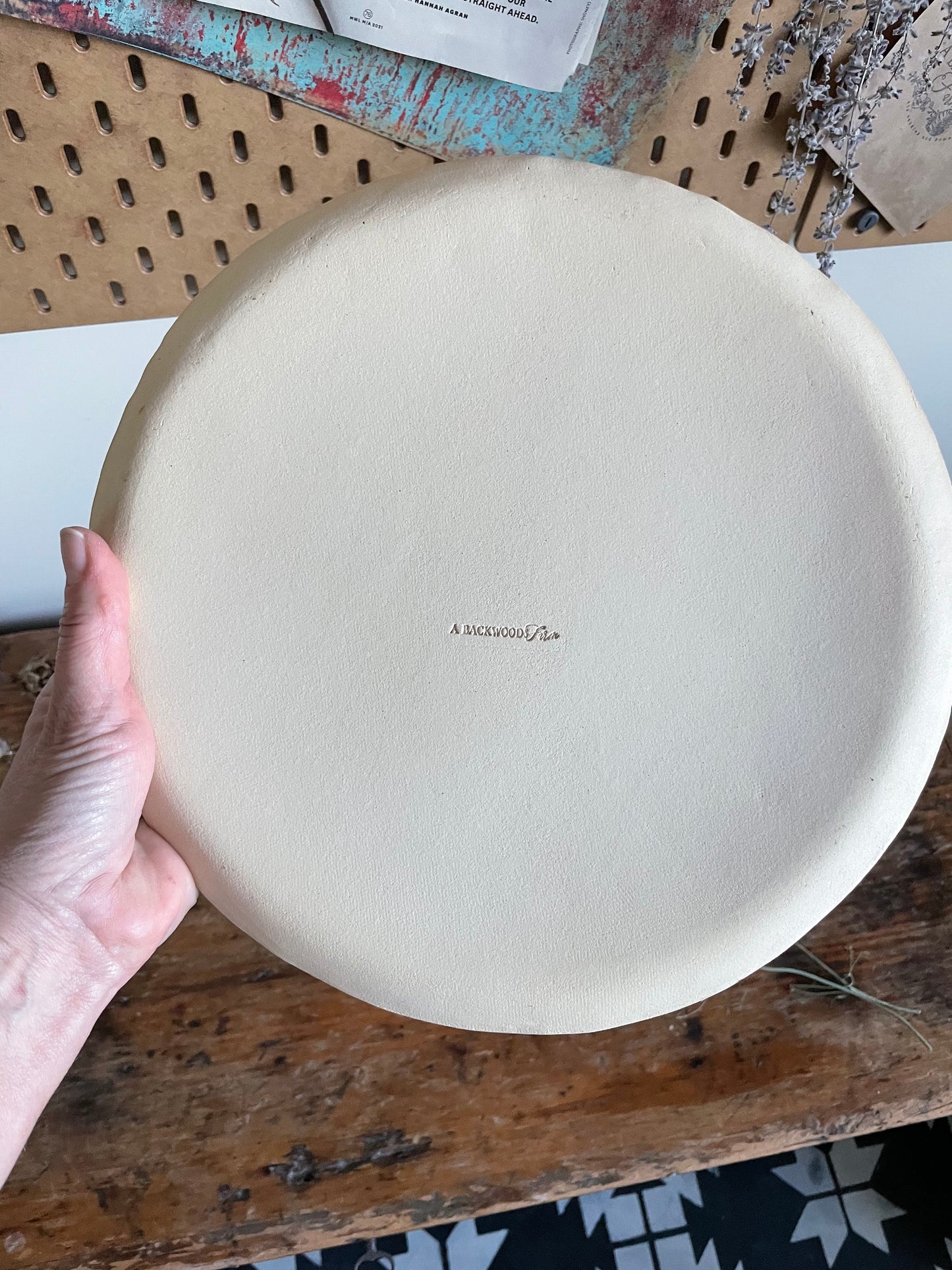 Back side of handmade pottery showing makers mark A Backwoods Farm.