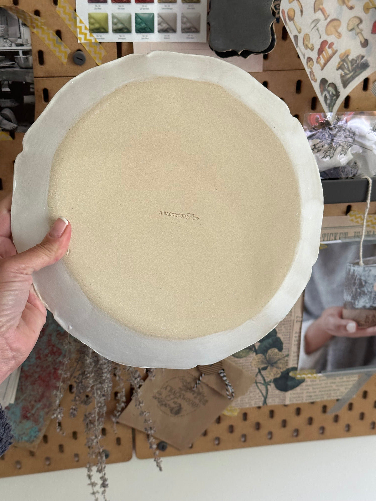 Back side of handmade dinner plate showing makers mark A Backwoodsfarm