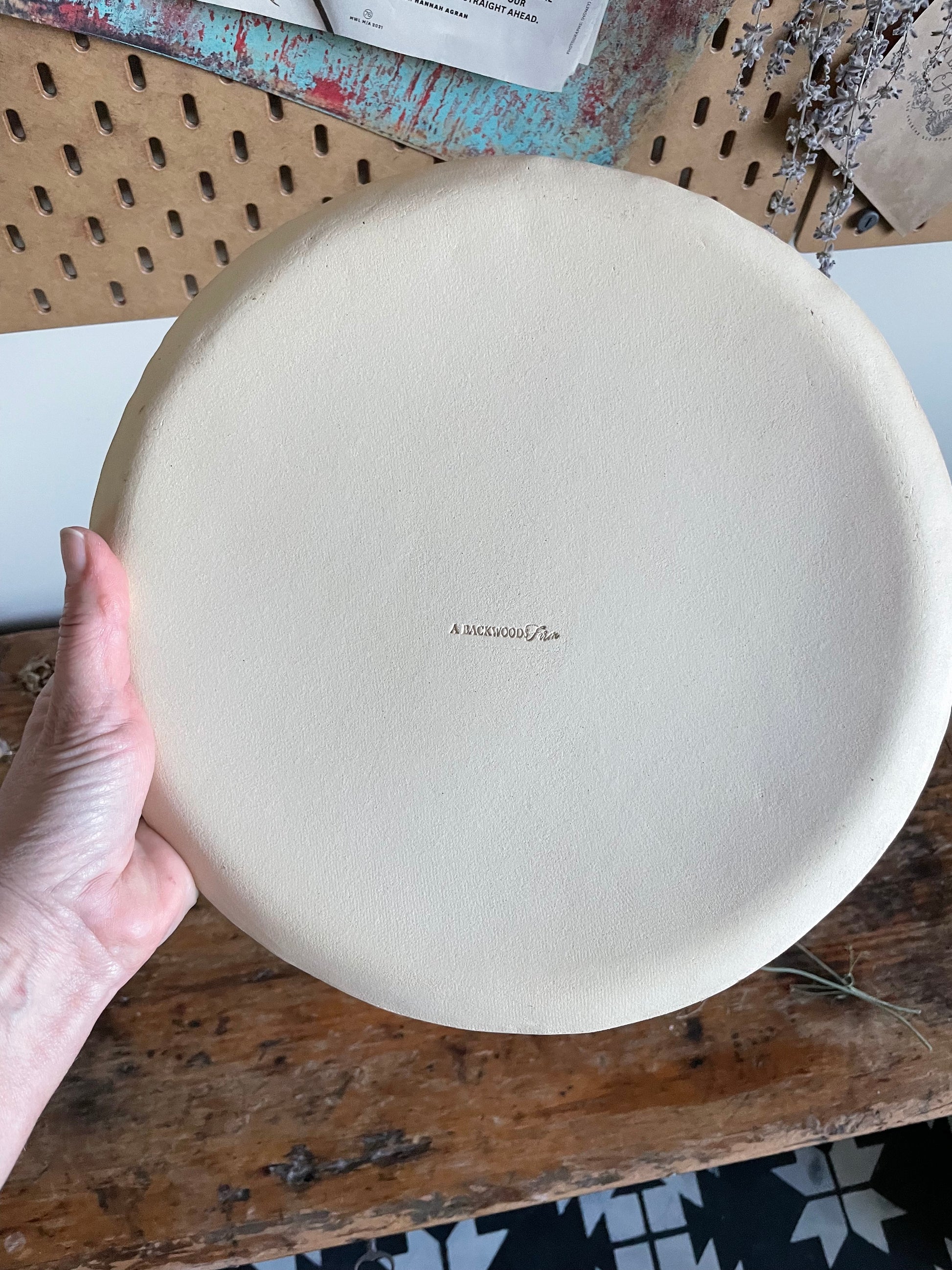 Back side of handmade pottery showing makers mark A Backwoods Farm.