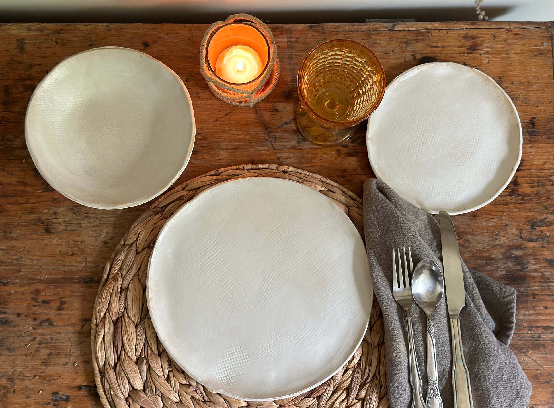 Handmade dinnerware set in matte white with a burlap texture. Set includes dinner plate, dessert plate and bowl.