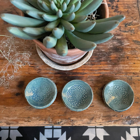 Three small trinket dishes with a boho pattern in a green glaze