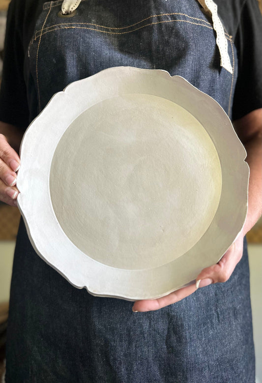 Large scalloped edge plate with smooth finish in matte white